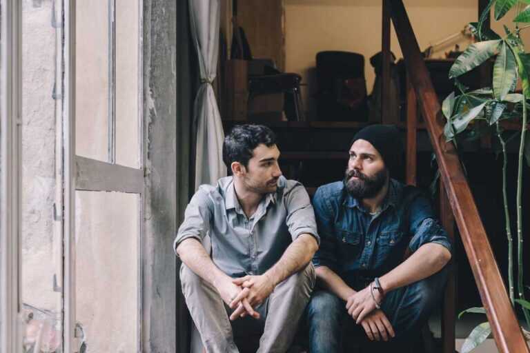 Couple of young men talking on the stairs